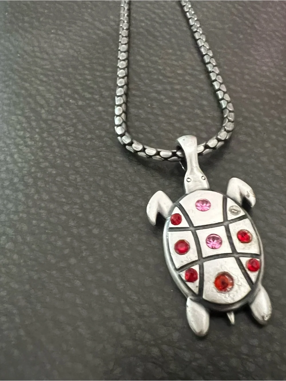 Silver tone Turtle Pendant Necklace with Red and Pink Accent Stones.